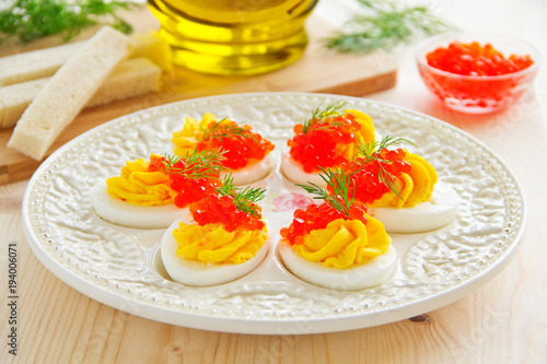 Eggs stuffed with creamy mousse and red caviar.