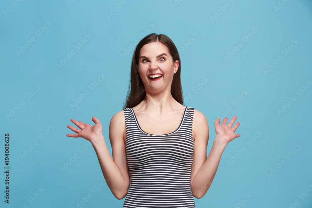 The squint eyed woman with weird expression isolated on blue The squint eyed woman with weird expression isolated on blue