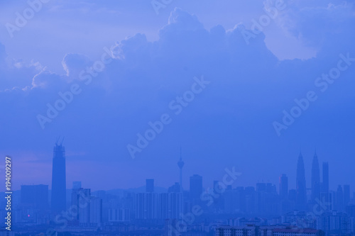 Kuala Lumpur city skyline during dusty morning with thick fog.