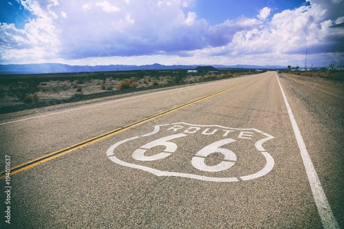 Famous Route 66 road marker on a California highway, USA. Vintage styling.
