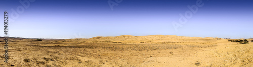 Wery wide panorama of desert hills under blue sky