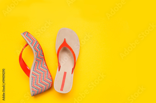 Bright summer women's sandal isolated on yellow background. Top view