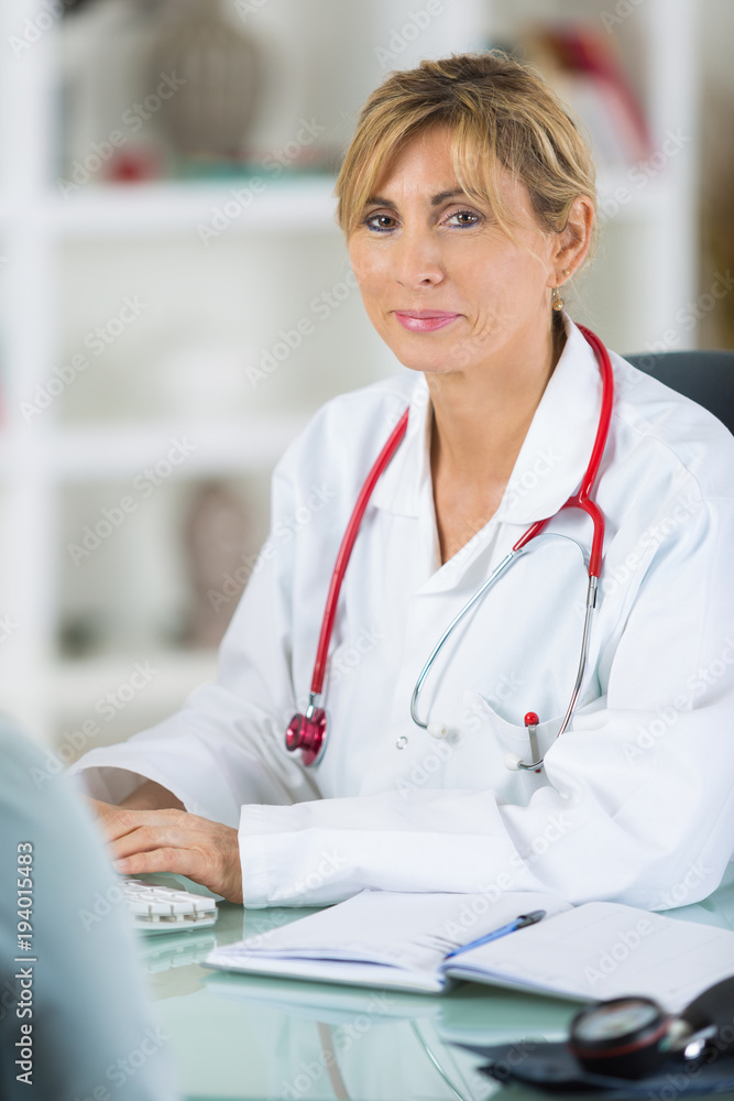 pensive female doctor at her desk pensive female doctor at her desk