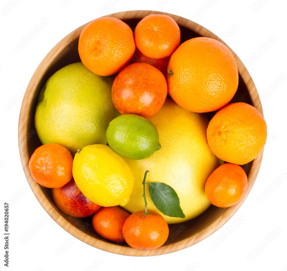 Isolated citrus fruits. Grapefruit, orange, lemon, lime and tangerines in a wooden bowl. Isolated citrus fruits. Grapefruit, orange, lemon, lime and tangerines in a wooden bowl.