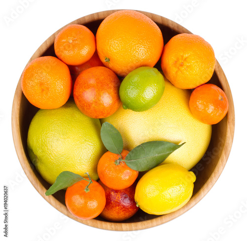 Isolated citrus fruits. Grapefruit, orange, lemon, lime and tangerines in a wooden bowl.