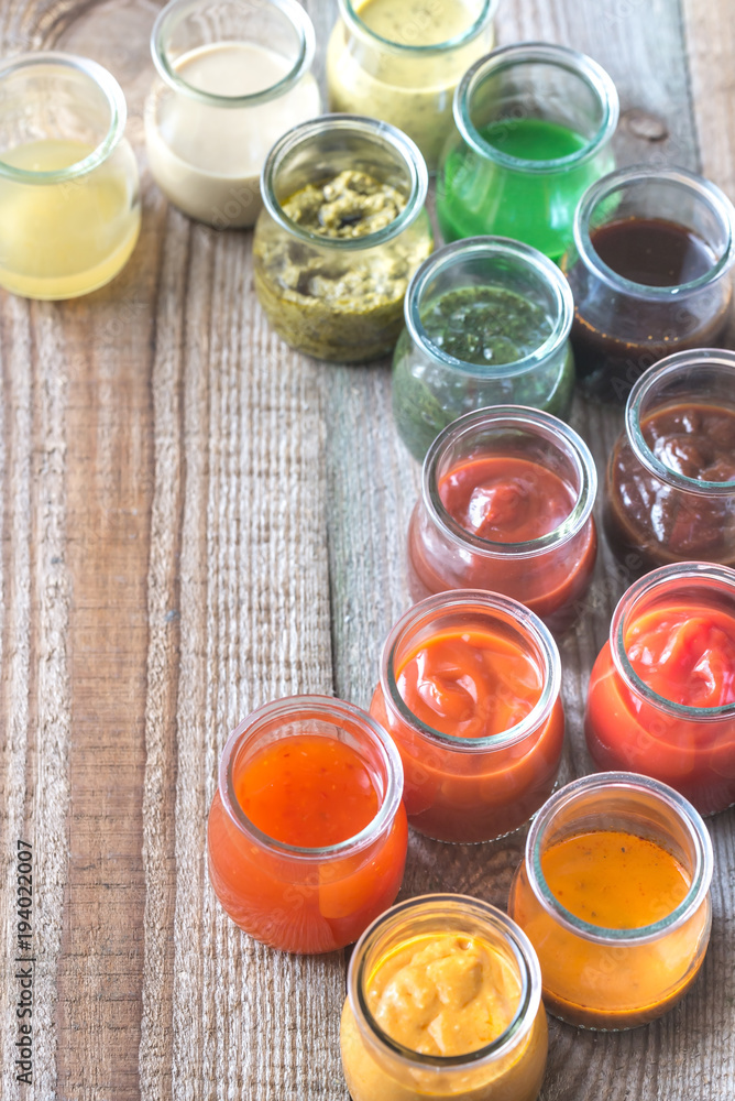 Assortment of sauces in the glass jars Assortment of sauces in the glass jars