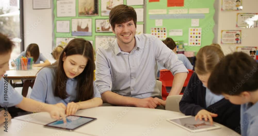 4K Portrait smiling school teacher in class with children drawing on digital tablets. Slow motion 4K Portrait smiling school teacher in class with children drawing on digital tablets. Slow motion