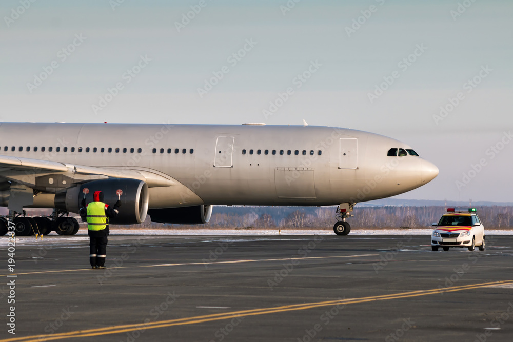 Passenger airplane is moving behind the follow me car. Airport ground crew meets aircraft Passenger airplane is moving behind the follow me car. Airport ground crew meets aircraft