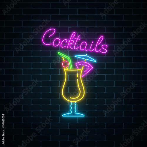 Glow neon sign of cocktails bar on dark brick wall background. Glowing gas advertising with pina colada