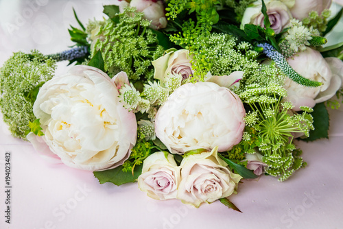 Bouquet of flowers from big peonies and pastel roses