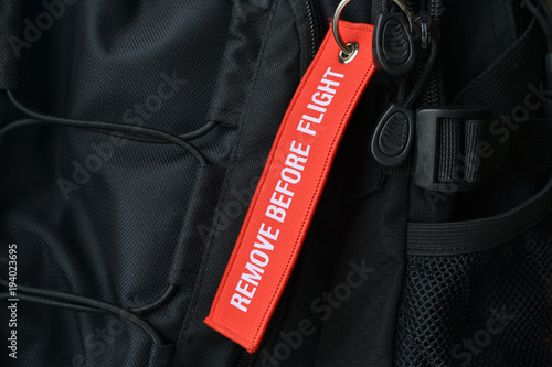 Air travel. Remove before flight. A tag on the backpack