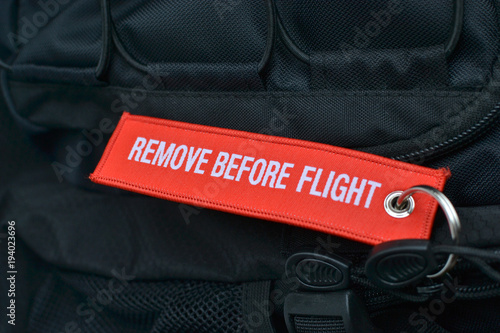 Air travel. Remove before flight. A tag on the backpack