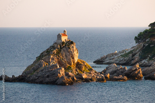 Sveta Nedelja is an islet on the Adriatic Sea, in Montenegrin municipality of Budva..It is located opposite the town of Petrovac na Moru in Montenegro.  It has a small church on it. photo