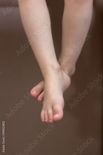 Baby feet. Kid toes while k...
