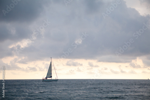 Sailboat in the sea on mountains background, luxury summer adventure, active vacation