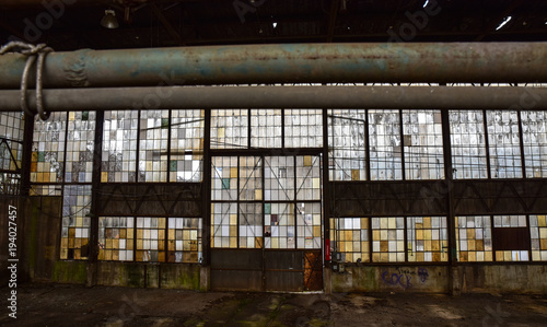Broken windows in abandoned warehouse industrial space
