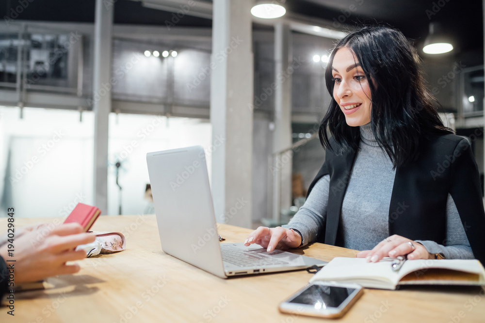 young beautiful woman indoor using computer sitting working desk - business, technology, meeting concept young beautiful woman indoor using computer sitting working desk - business, technology, meeting concept