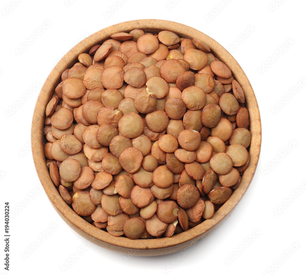 Pile lentil in wooden bowl isolated on white background. Top view. Pile lentil in wooden bowl isolated on white background. Top view.