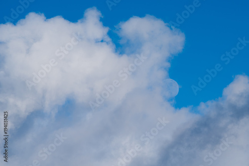 cloudy sky with moon in background