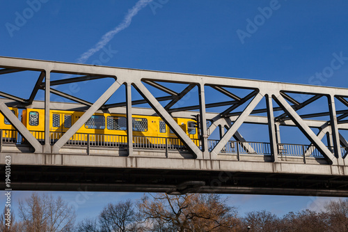 Photography BERLIN, GERMANY - FEBRUARY 22, 2017: Yellow u-bahn train crossing the metal brid