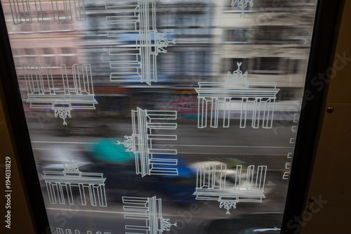Photography Berlin city in motion through window of u-bahn train with Reichstag logo