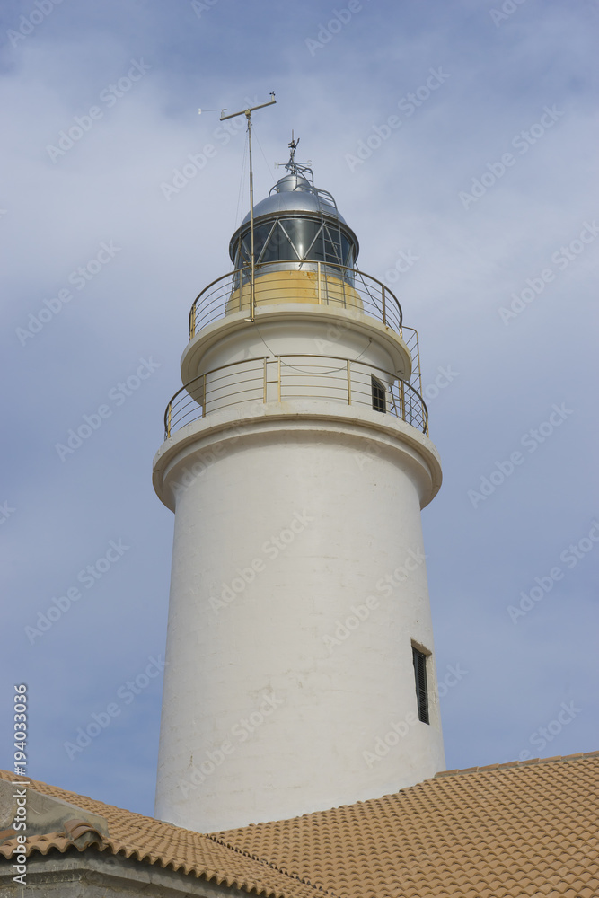 lighthouse next to the Mediterranean Sea, blue sky without clouds with calm waters. serves to warn ships of the presence of rocks lighthouse next to the Mediterranean Sea, blue sky without clouds with calm waters. serves to warn ships of the presence of rocks