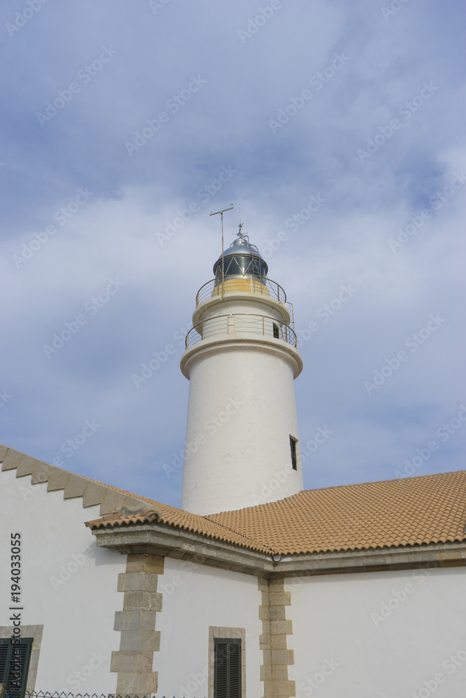 lighthouse next to the Mediterranean Sea, blue sky without clouds with calm waters. serves to warn ships of the presence of rocks