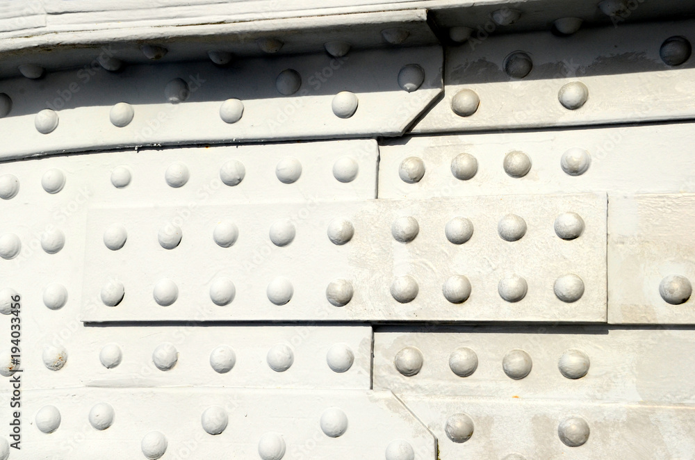 Closeup on elder gray steel structure with a lot of rivets. Closeup on elder gray steel structure with a lot of rivets.