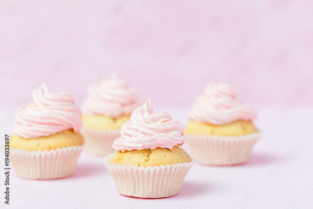 Cupcake decorated with pink buttercream on pastel pink background. Sweet beautiful cake. Horizontal banner, greeting card for birthday, wedding, women's day. Close up photography. Selective focus Cupcake decorated with pink buttercream on pastel pink background. Sweet beautiful cake. Horizontal banner, greeting card for birthday, wedding, women's day. Close up photography. Selective focus