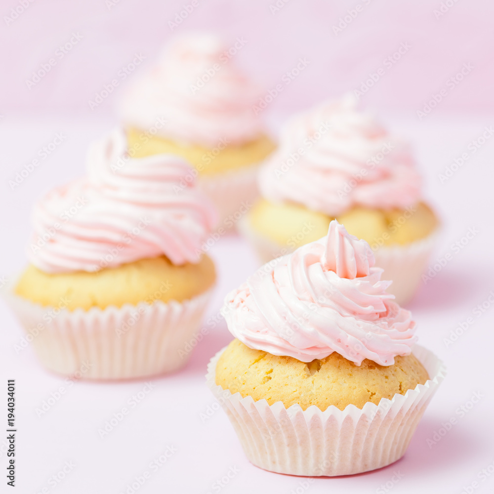 Cupcake decorated with pink buttercream on pastel pink background. Sweet beautiful cake. Square banner, greeting card for birthday, wedding, women's day. Close up photography. Selective focus