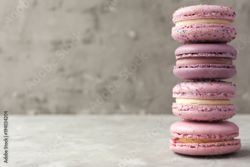 Pink and violet macarons on light background. Copy space. photo