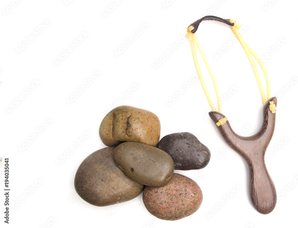 Slingshot Representing the Fight Between David and Goliath on a White