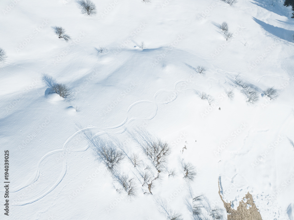 Aerial view of traces of ski in snow covered landscape