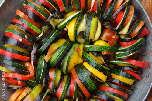 Ratatouille. Vegetable dish. Peasant food. Vegetables, cut into slices. Zucchini, pepper, tomato, eggplant. Delicious. It is useful. Close-up. Horizontal photo