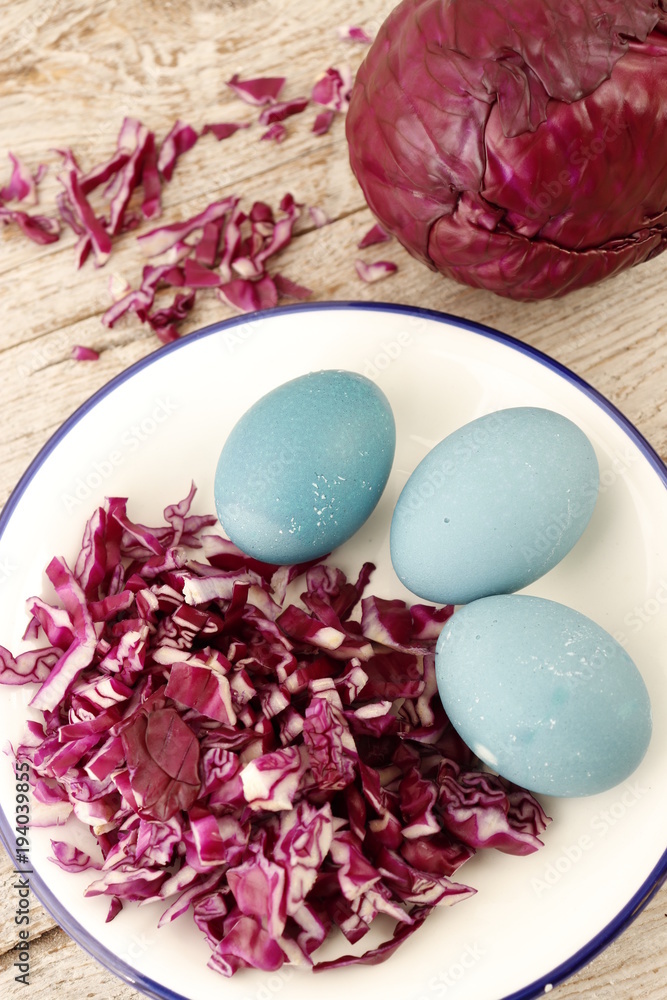 The concept of staining eggs with natural means. Eggs stained in broth of red cabbage.