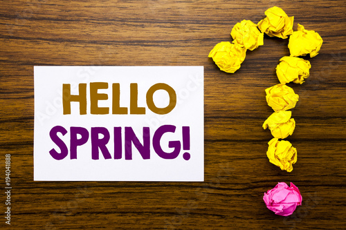 Handwritten text showing Hello Spring!. Business concept for Summer Time Welcoming Written on sticky note paper, wooden background with question mark from sticky note. For asking questions.