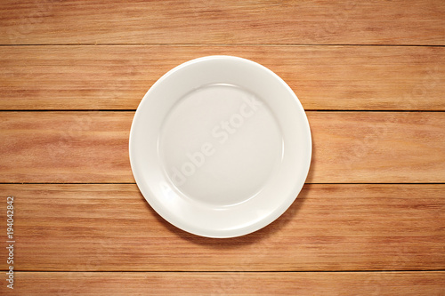 Empty Plate  Fork  Knife and Table Cloth on wooden background. Top View with Text Space