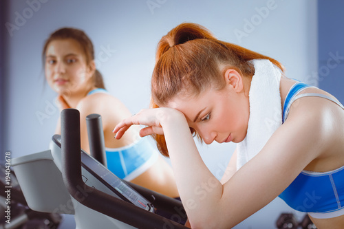 Group of people at the gym exercising on cross trainers. people at the gym photo