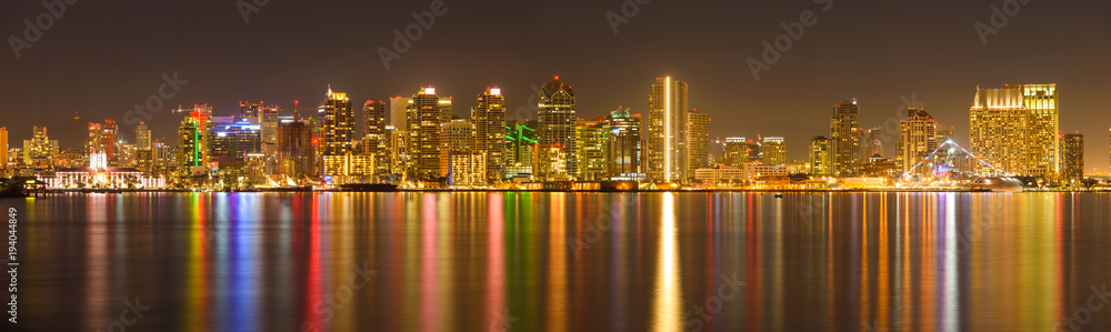Fototapeta premium San Diego Skyline at Night - A panoramic night view of west side of San Diego Downtown Skyline by the Norht San Diego Bay, San Diego, California, USA.