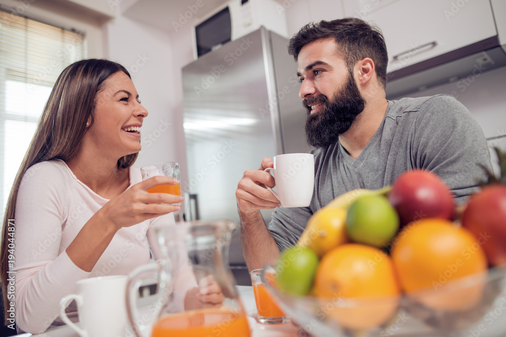 Young happy couple having breakfast together. Young happy couple having breakfast together.