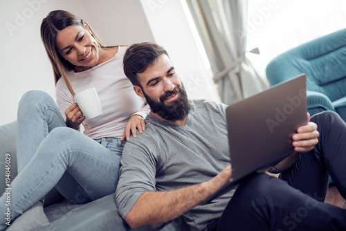 Couple enjoying at home,watching a movie.