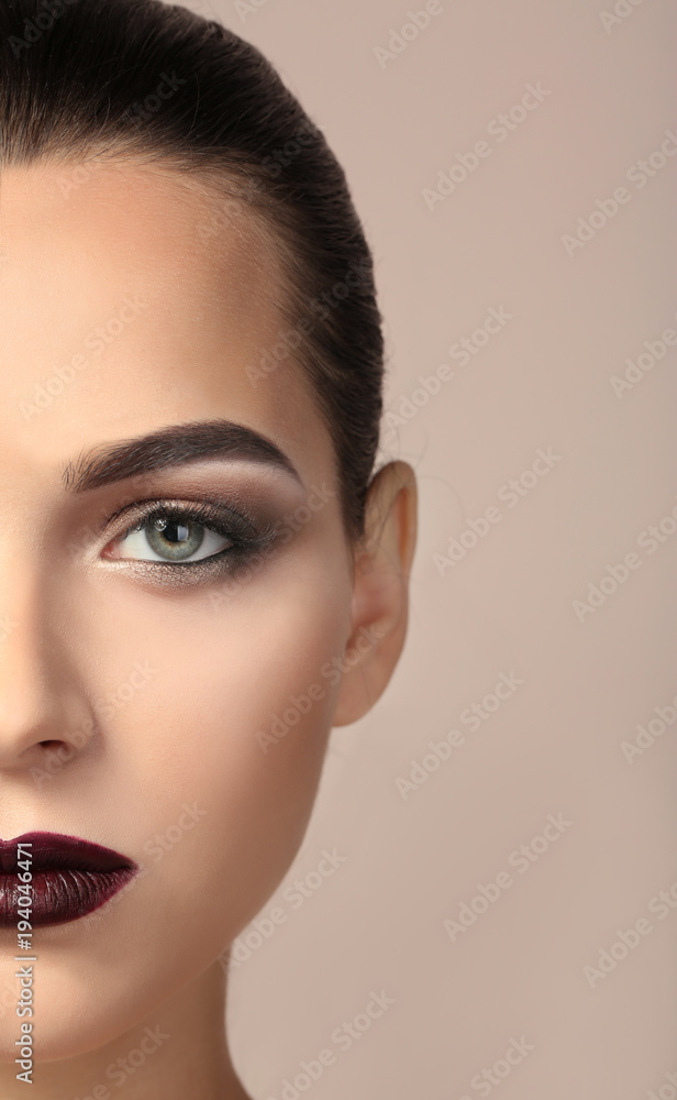 Fototapeta premium Woman with beautiful makeup on light background. Professional visage artist work
