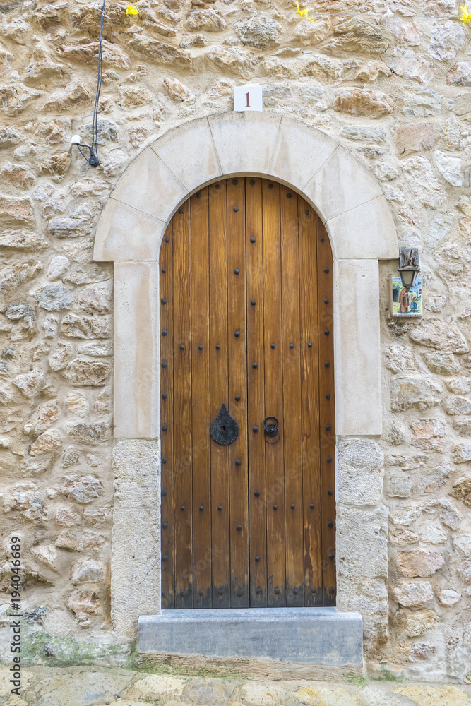 old wooden door in a coastal village of the island of Mallorca in Spain, next to the mediterranean sea, vacation and rest concept
