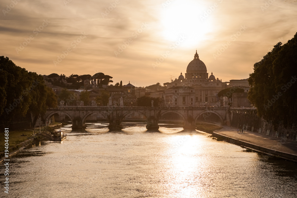 Famous cityscape of Rome with Basilica Di San Pietro in Vatican and Ponte Sant Angelo in foreground, Rome, Italy