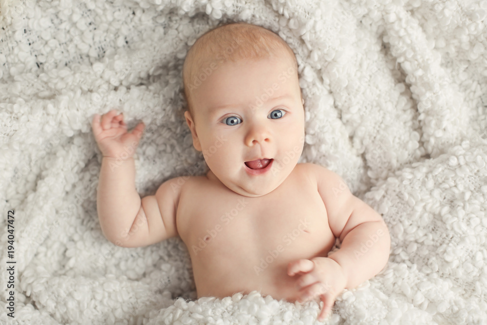 Cute little baby lying on plaid, top view Cute little baby lying on plaid, top view