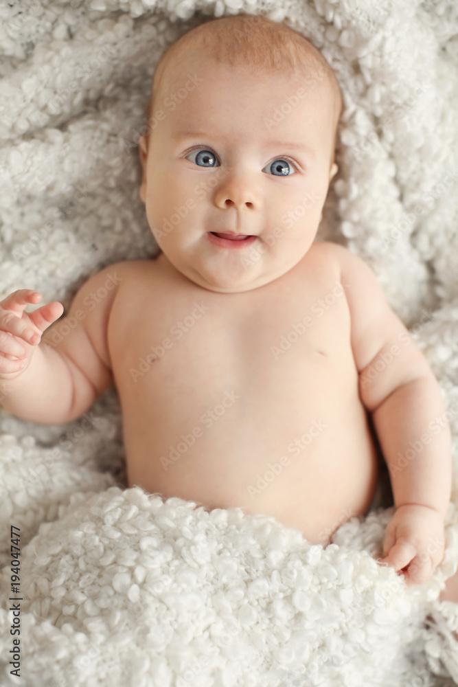 Cute little baby lying on plaid, top view Cute little baby lying on plaid, top view