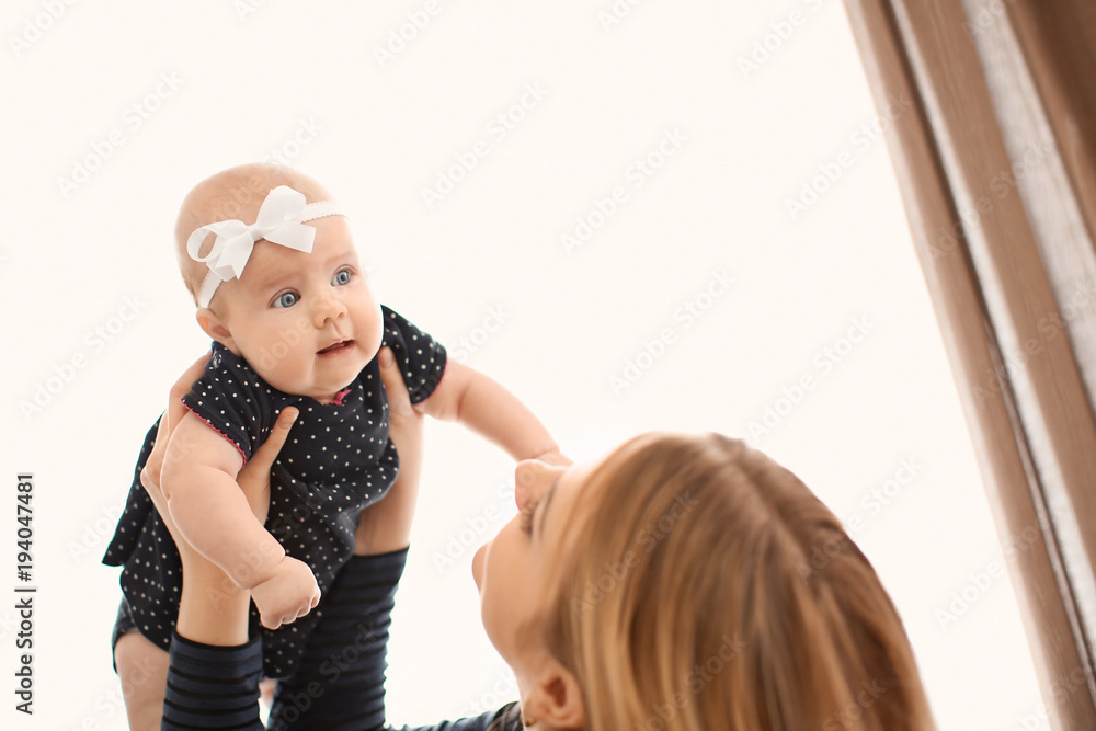 Fototapeta premium Young mother with her baby at home