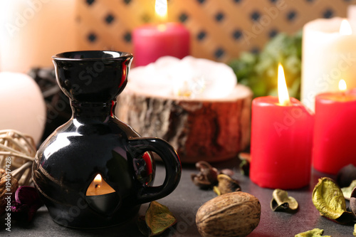 Aroma lamp and candles on table