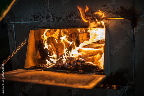 Obraz na plátně Burning pile of wood in the stove