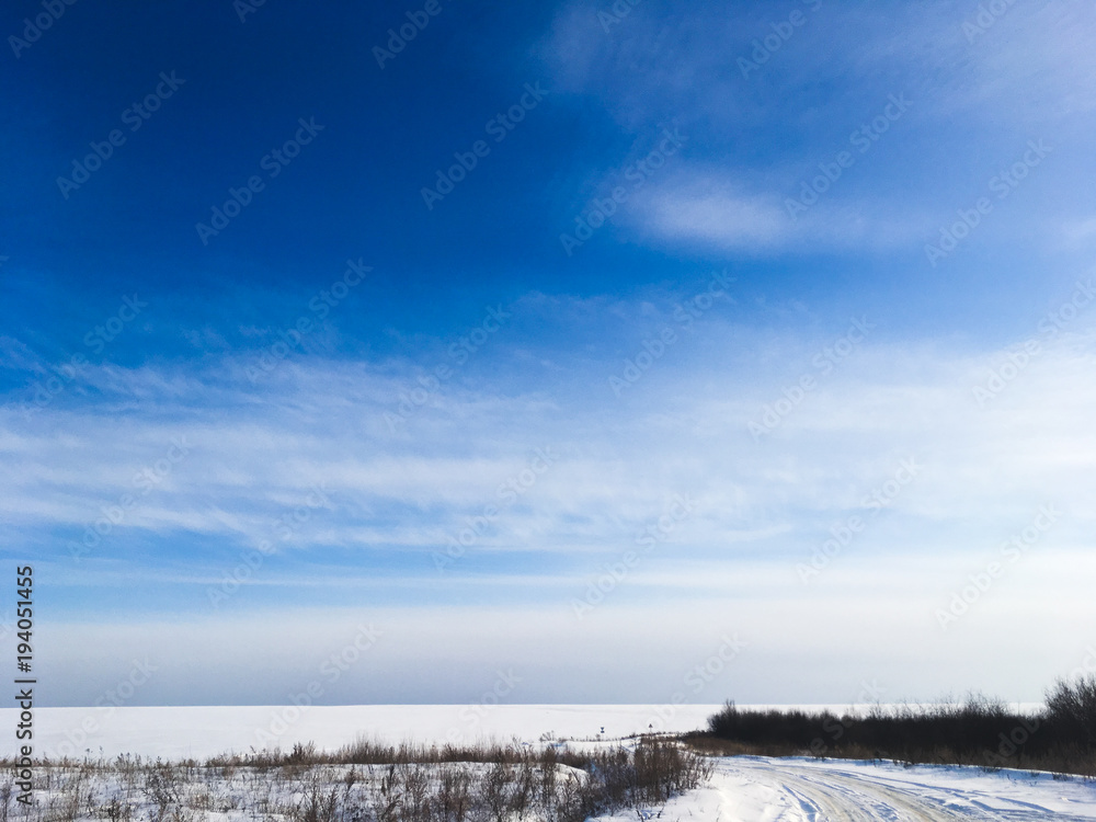 Russian winter nature, fields, forests and blue sky